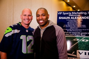 Seahawk great Shaun Alexander (right) posing with VIP guest  